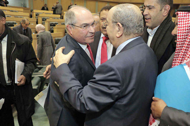 Prime Minister Hani Mulki (left) is congratulated by MPs and officials after his government survived a vote of no-confidence on Monday (Photo by Osama Aqarbeh)