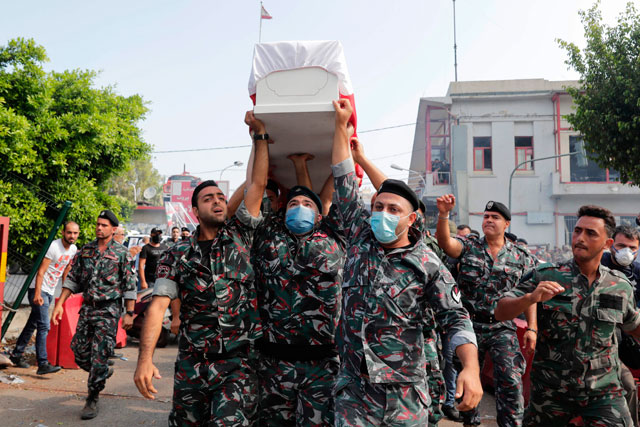 Firefighters carry the coffin of their colleague Joe Noun, who was killed in Beirut's massive blast, during his funeral at the fire station in Karantina neighbourhood near the port on Wednesday (AFP photo)