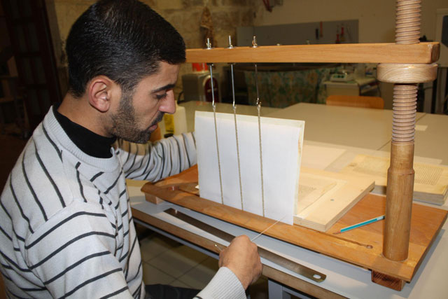 In this recent photo shared by the Manuscripts Restoration Centre in Jerusalem on its Facebook page, a worker works on restoring an ancient manuscript (Photo courtesy of Manuscripts Restoration Centre)