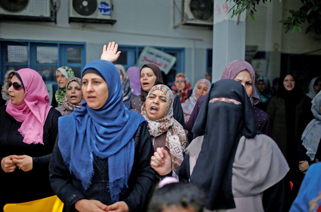 UNRWA employees take part in a protest against jobs termination by UNRWA inside its headquarters in Gaza City on Sunday (Reuters photo)