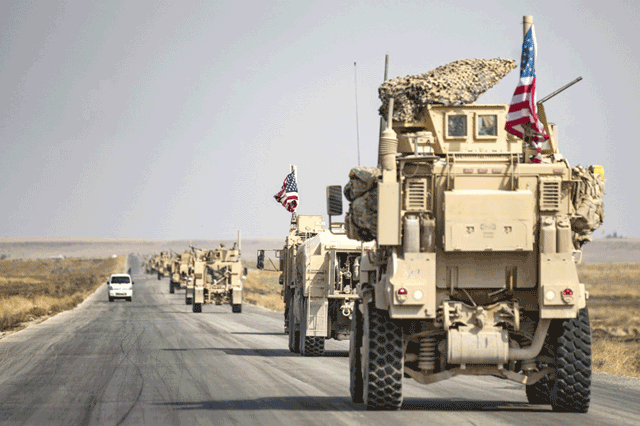 US military vehicles drive on a street in the town of Tal Tamr on October 20, 2019, after pulling out of their base (AFP photo)