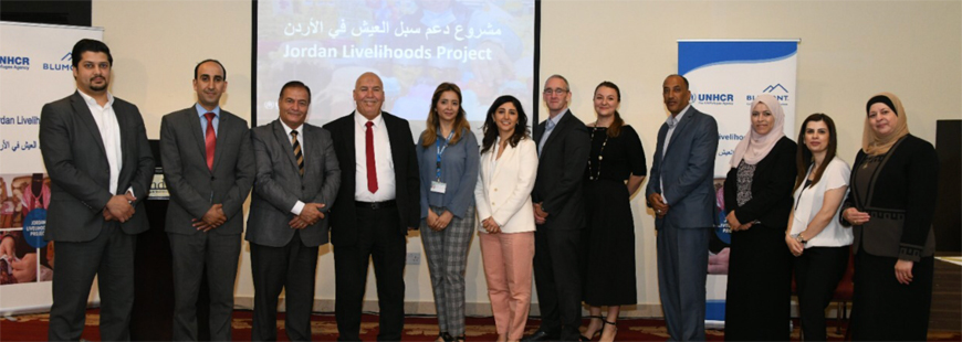 Guests pose for a photo during a signing ceremony, where UNHCR Jordan and Blumont, an NGO that provides relief for refugees and host populations, signed six agreements with various community-based organisations, on Wednesday (Photo courtesy of Blumont)