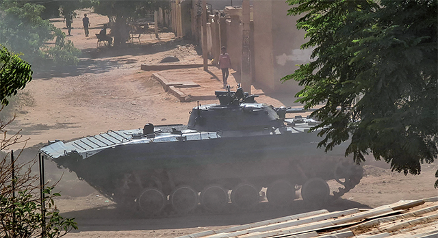 A Sudanese army armoured vehicle is stationed in southern Khartoum on Sunday, amid ongoing fighting between two rival generals (AFP photo)