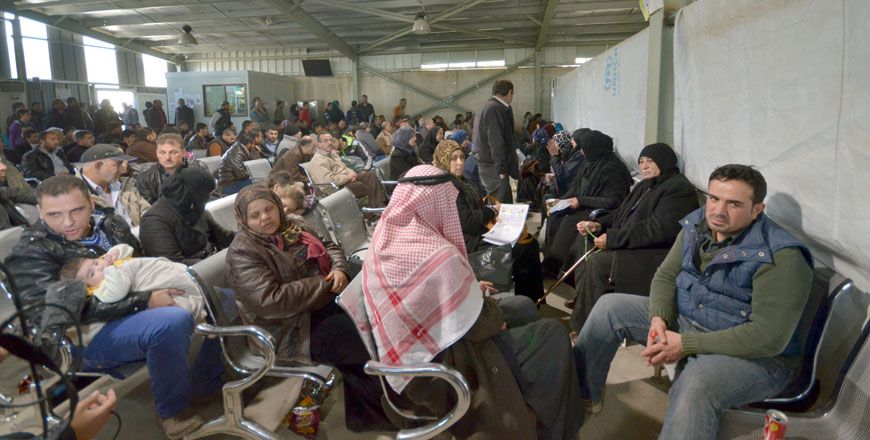 Syrian refugees wait in a hall at the UNHCR office in Amman on Friday before they are called to be interviewed (Photo by Muath Freij)