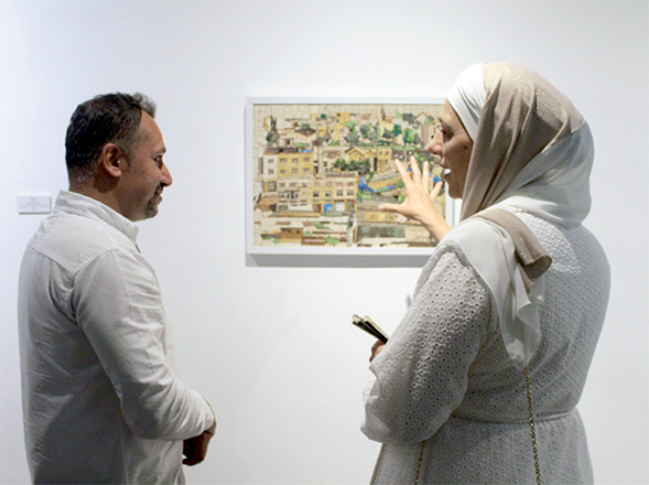 HRH Princess Basma Bint Ali speaks with a Jordanian artist during the opening of mosaic exhibits at the Jordan National Gallery of Fine Arts on Monday (Photo by Taija PerryCook)