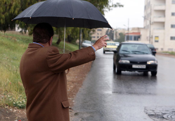 A man hails a taxi on a street in Amman on Sunday (Photo by Khaled Oudat)