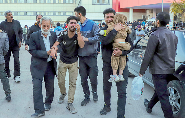 People injured in two explosions in quick succession that struck a crowd marking the anniversary of the 2020 killing of Guards General Qassem Soleimani, are helped outside a hospital in the southern Iranian city of Kerman on Wednesday (AFP photo)
