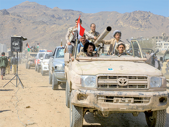 Armed Yemeni supporters of the Houthi movement sit on the back of an armoured vehicle during an anti-Israel and anti-US rally in the Houthi-controlled capital Sanaa on Monday (AFP photo)