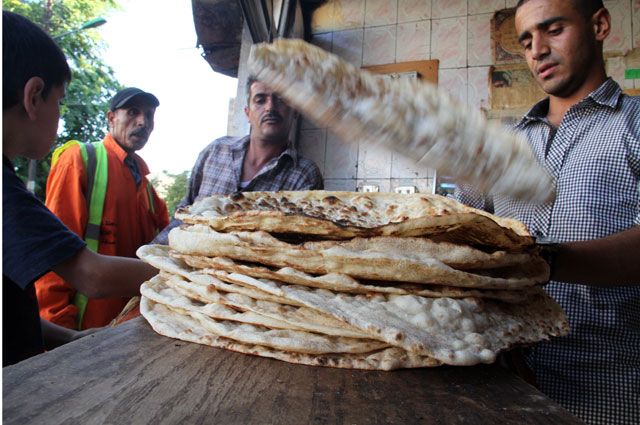 A baker prepares bread in downtown Amman recently. Consumers say prices of food items are lower this Ramadan than in previous years (Photo by Osama Aqarbeh)