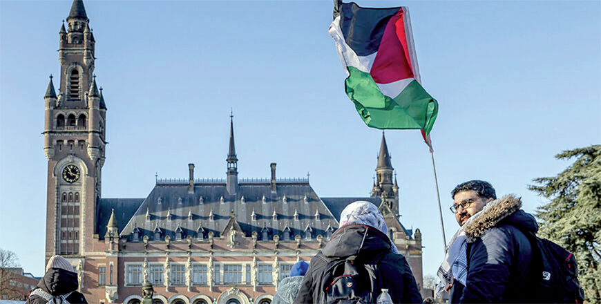 A demonstrator  waves the Palestinian flag in front of the Peace Palace ahead of the International Court of Justice verdict in the genocide case against Israel, brought by South Africa, in The Hague on January 26 (AFP photo)