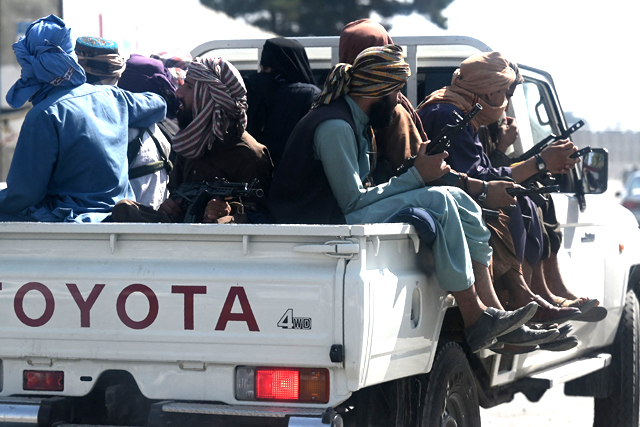 Taliban fighters patrol on a vehicle outside Kabul International Airport in Kabul on Saturday (AFP photo)