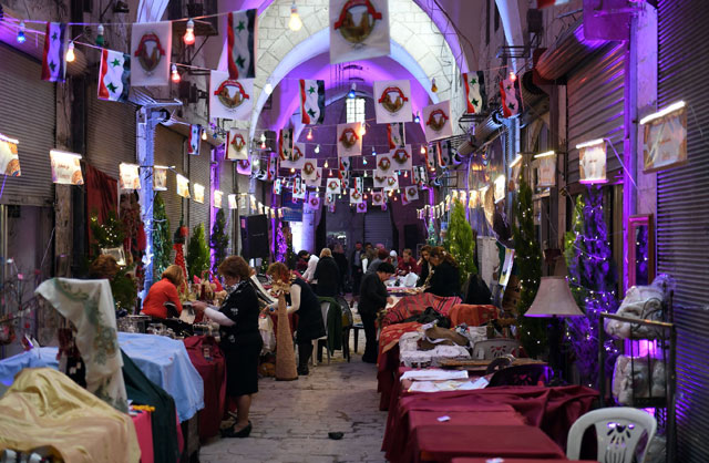 Syrians prepare merchandise for sale during a celebration in Aleppo’s historic souk as it reopens on Thursday (AFP photo)