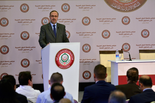 Minister of State for Media Affairs Mohammad Momani speaks to reporters at the Arab summit’s media centre at the Dead Sea (Photo by Amjad Ghsoun)