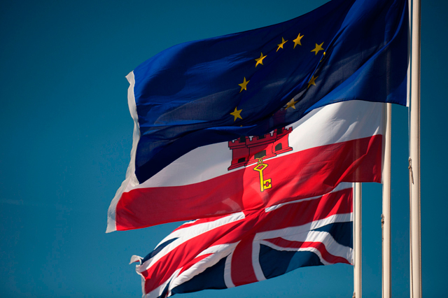 A Union Jack flag (down), the flag of Gibraltar (centre) and the European Union flag fly in Gibraltar, on Tuesday (AFP photo)