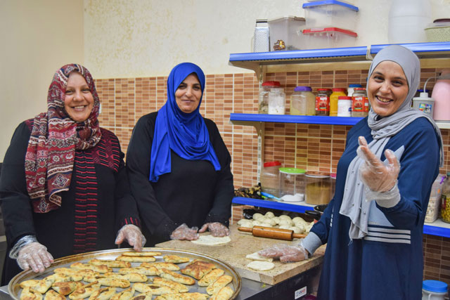 Um Mohammad is seen with some of her production kitchen employees in Irbid recently (Photo courtesy of USAID LENS)