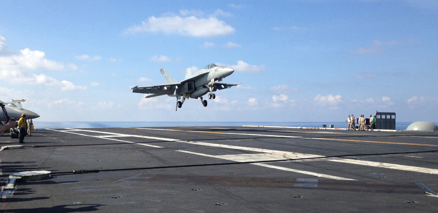 This April 15 file photo, an FA-18 jet fighter lands on the USS John C. Stennis aircraft carrier in the South China Sea (AP photo)
