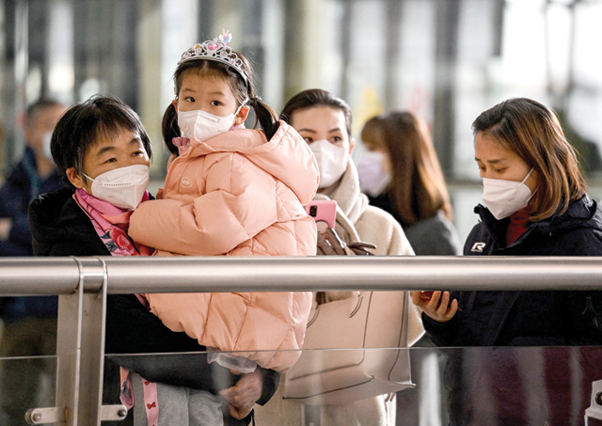 People wait for their relatives at the arrivals area for international flights at the Capital International Airport in Beijing on Sunday (AFP photo)