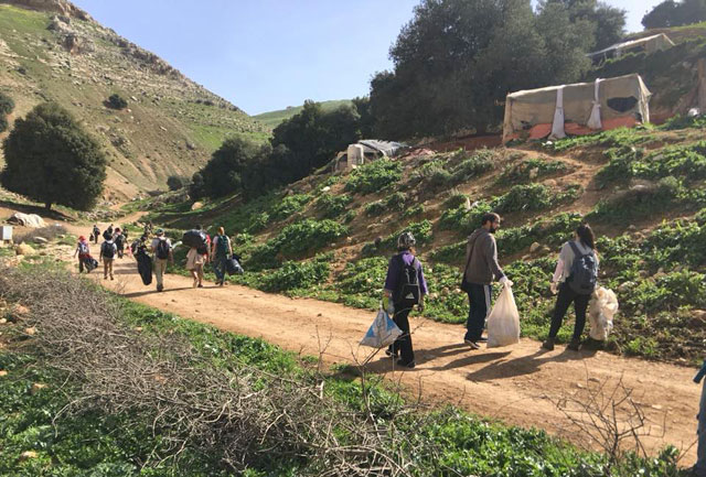 Teams of five people collect garbage during a hike between Rumaymeen and Salt on Friday  (Photo courtesy of ECO Hikers)
