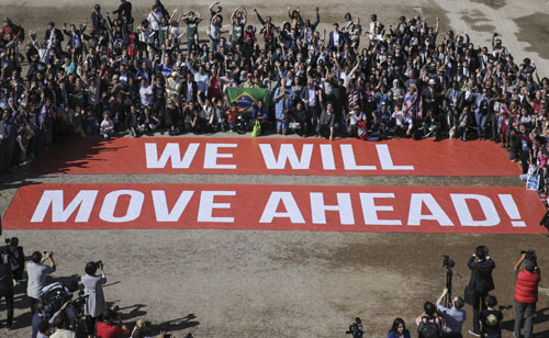 Participants at the COP22 climate conference stage a public show of support for climate negotiations and Paris agreement, on the last day of the conference, in Marrakech, Morocco, on Friday (AP photo)