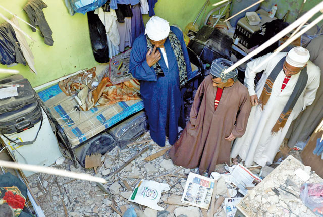 People check the damage created by debris  after ballistic missiles fired by Yemen's Houthi militia fell at a house in Riyadh, Saudi Arabia, on Monday (Reuters photo)
