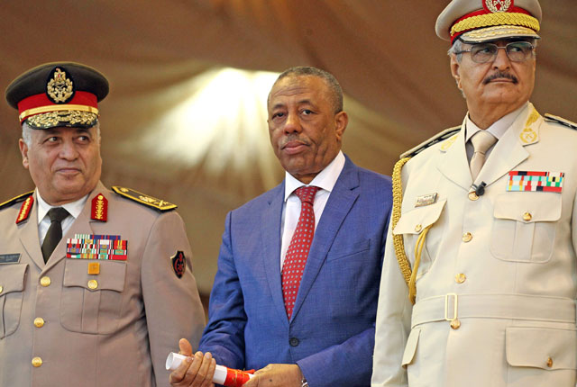 Libyan strongman Khalifa Haftar (right), former prime minister Abdullah Al Thani (centre), who now heads the government that operates from the eastern Libyan city of Bayda, and Egyptian Army Chief of Staff Sedky Sobhy attend a military parade in the eastern city of Benghazi on Monday (AFP photo)