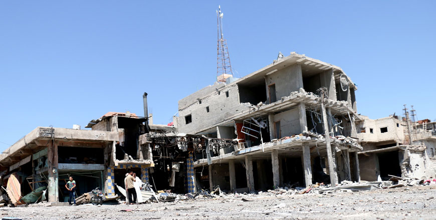 Residents inspect buildings damaged by air strikes in the rebel-held town of Nawa, about 30 kilometres north of Daraa in southern Syria, on Wednesday. More than a dozen civilians were killed when unidentified air strikes hit the town of Nawa during the night (AFP photo)