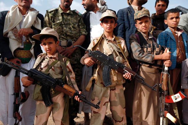 Yemeni children carrying weapons take part in a gathering organised by Shiite Houthi rebels to mobilise more fighters to battlefronts to fight pro-government forces, on Sunday, in the capital Sanaa (AFP photo)