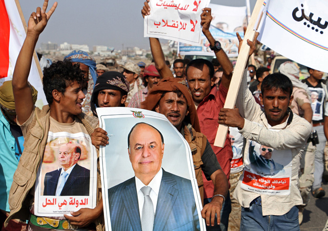 In this file photo taken on November 2, 2016, Yemenis hold portraits of Saudi-backed Yemeni President Abed Rabbo Mansour Hadi as they demonstrate in the southern port city of Aden on November 3, 2016 (AFP photo)