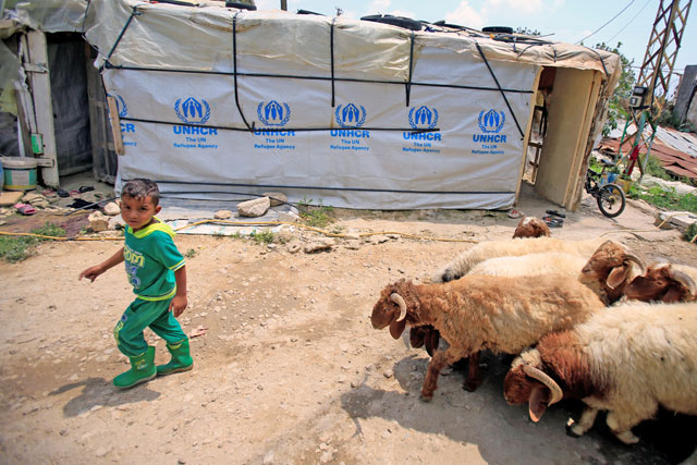 A Syrian refugee boy walks at a refugee camp in Zahrani town in southern Lebanon on Wednesday (Reuters photo)