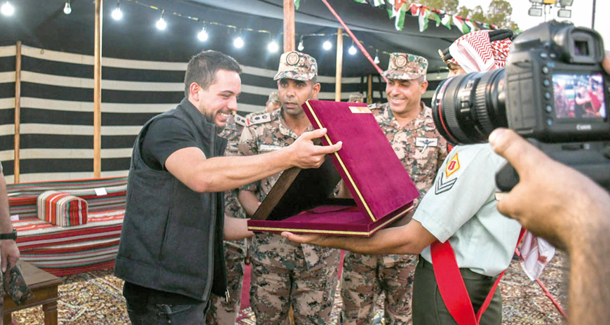 HRH Crown Prince Hussein is seen with soldiers, whose unit celebrated his 24th birthday, which falls today (Photo courtesy of Royal Court)