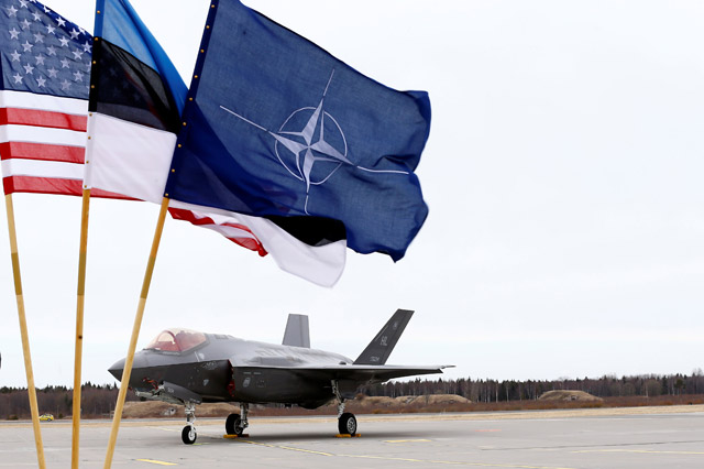 US, Estonia's and NATO flags flutter next to the US Air Force F-35A Lightning II fighter in Amari Airbase, Estonia, on Tuesday (Reuters photo)