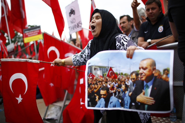 Supporters of Turkish President Recep Tayyip Erdogan wave Turkish flags during a pro-government protest in Cologne, Germany, on Saturday (Reuters photo)