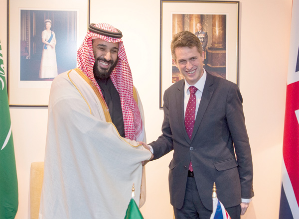Crown Prince and Defence Minister of Saudi Arabia Mohammad Bin Salman Al Saud (left) and British Secretary of State for Defence Gavin Williamson shake hands as they pose for a photo during their meeting in London, United Kingdom, on Friday (Anadolu Agency photo)