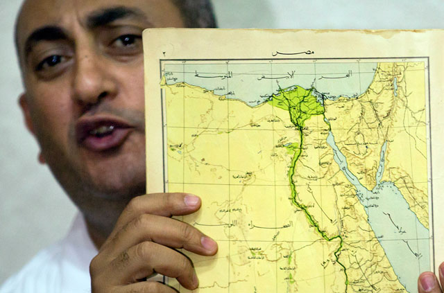Egyptian lawyer and former presidential candidate Khaled Ali displays an old map of Egypt including the two disputed Red Sea islands, during a press conference, in Cairo, Egypt, on Wednesday (AP photo)