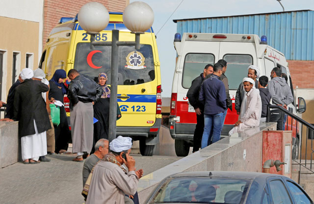 Relatives of victims of the explosion at the Rawda mosque, wait near ambulances outside Suez Canal University Hospital in Ismailia, Egypt, on Saturday (Reuters photo)