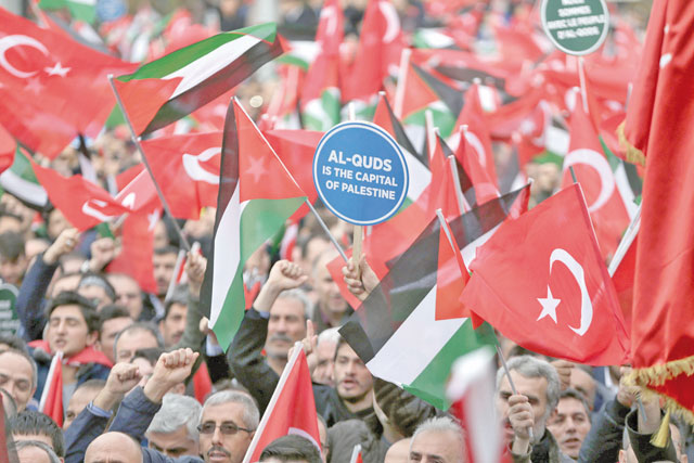 A protester holds a banner reading ‘Al Quds Is The Capital Of Palestine’ during a demonstration against US President Donald Trump's recognition of Jerusalem as Israel's capital at Gazi Mustafa Kemal Boulevard in Ankara, Turkey, on Sunday (Anadolu Agency photo)