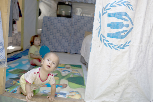 Syrian children play inside a tent at Ritsona Refugee Camp, north of Athens, which hosts more than 600 refugees and migrants, on Thursday (AP photo)
