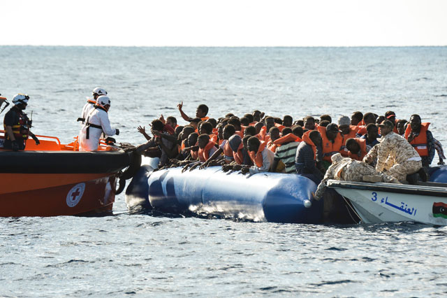This photo taken on November 4, 2016 shows migrants and refugees sitting on a rubber boat during a rescue operation of the Topaz Responder, a rescue ship run by Maltese NGO ‘Moas’ and the Italian Red Cross with the help of the Libyan coastguards, off the Libyan coast (AFP photo)