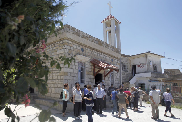 Worshippers attend mass at a church in the Druze village of Ein Qiniye in the occupied Golan Heights on June 11 (AFP photo)