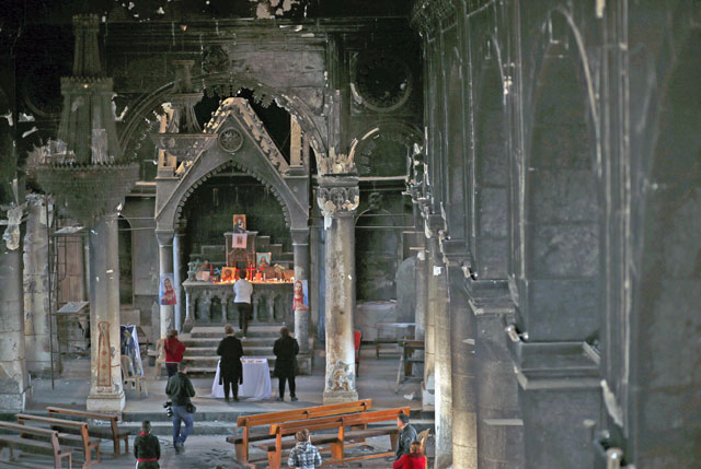 Iraqi Christians come to visit the heavily damaged Church of the Immaculate Conception after Iraqi forces recaptured it from Daesh in Qaraqosh, near Mosul, Iraq, on Friday (Reuters photo)