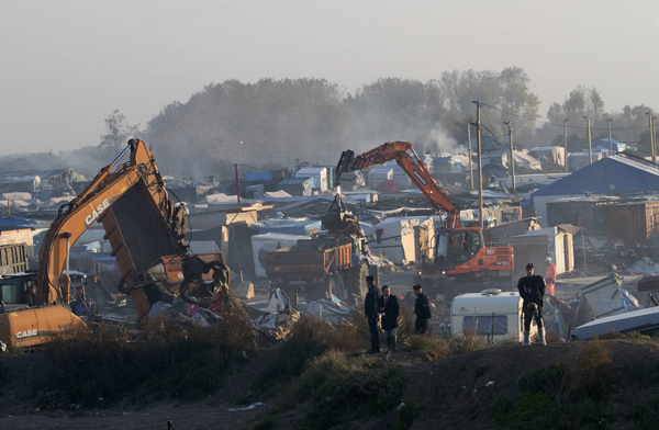 Bulldozers are used to tear down makeshift shelters and tents during the dismantlement of the camp called the ‘Jungle’ in Calais, France, on Thursday (Reuters photo)