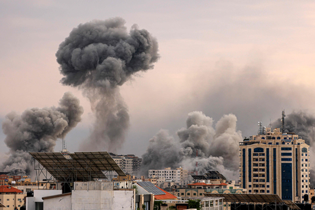 A plume of smoke rises in the sky of Gaza City during an Israeli air strike on Monday (AFP photo)