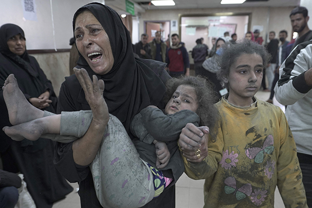 Wounded Palestinians arrive for treatment at the Al Aqsa Martyrs Hospital after Israeli bombardment in Deir Balah in the central Gaza Strip on Saturday (AFP photo)