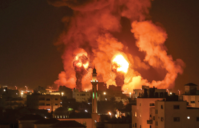 Fires are seen following an Israeli air strike in Gaza city on Saturday (AFP photo)