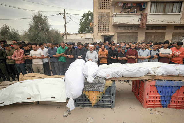 Palestinians mourn during the funeral of members of the Qudaih and Alshrafi families killed in overnight strikes on the southern Gaza Strip, in Khan Yunis on Monday, amid Israeli bombardment of Gaza (AFP photo)