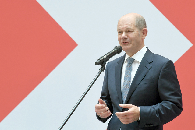 German Finance Minister, Vice-Chancellor and the Social Democrats (SPD) candidate for Chancellor Olaf Scholz delivers a press statement at the party's headquarters in Berlin on Monday, one day after general elections (AFP photo)