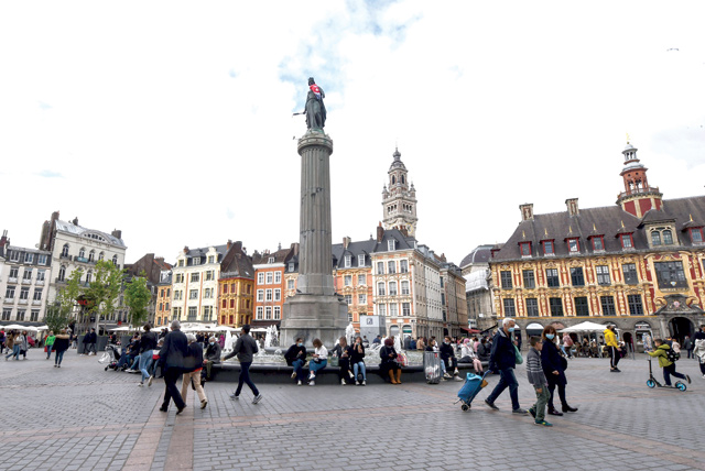 People sit in front of the Colonne de la Deesse, in Lille, northern France, on Wednesday as cafes, restaurants and other businesses reopened after closures during the coronavirus (COVID-19) pandemic (AFP photo)