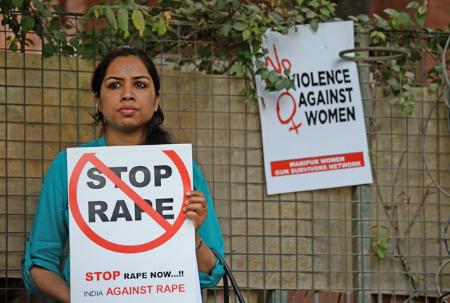 This file photo taken on February 21 shows an Indian social activist holding a placard during a protest against a rape at Hauz Khas village in New Delhi (AFP photo)