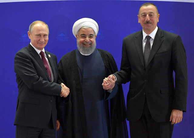 Left to right: Russia's President Vladimir Putin, Iran's President Hassan Rouhani and Azerbaijan's President Ilham Aliyev shake hands while posing for a photo during a meeting in Tehran, Iran, on Wednesday (Reuters photo)