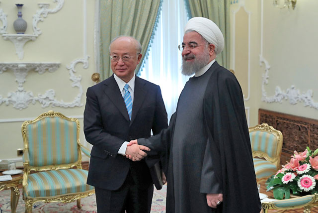 In this photo released by the official website of the office of the Iranian presidency, President Hassan Rouhani (right) and Director General of the International Atomic Energy Agency Yukiya Amano shake hands for media at the start of their meeting at the presidency office in Tehran on Sunday (AP photo)